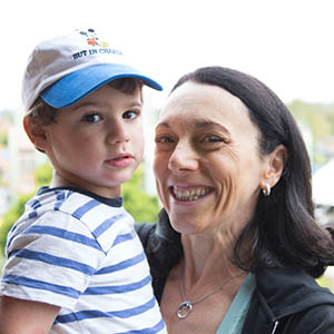 Young boy being held by his grandmother