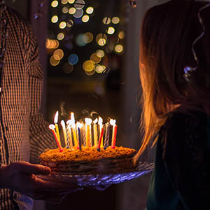 Woman preparing to blow out the candles on a cake