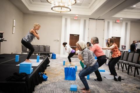 Participants at the Survivorship Expo practicing yoga