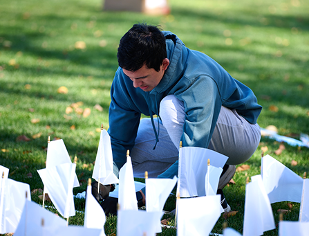 Man kneeling at flags