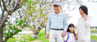 Grandparents and child walking outdoors
