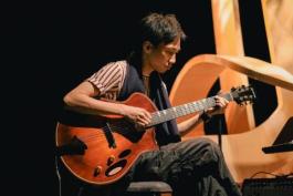 Teriver Cheung Playing Guitar