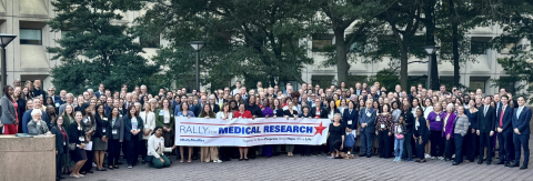 large group of advocates holding banner "rally for medical research"