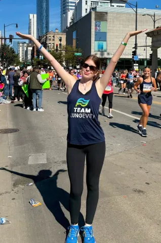 woman with hands up during marathon