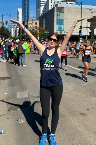 woman with hands up during marathon