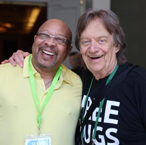 two adult men smiling