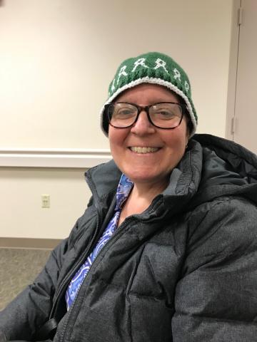 Michelle in wheelchair smiling at the radiation center