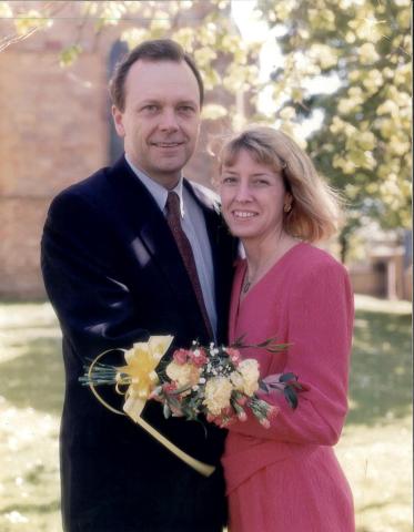 Tom and Mary Lynn dressed up smiling at the camera together